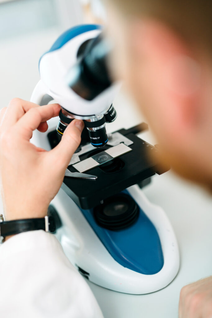 woman looking at microscope